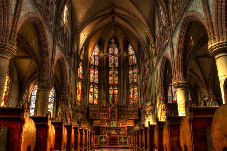 Image of an interior of a church with stained glass windows.