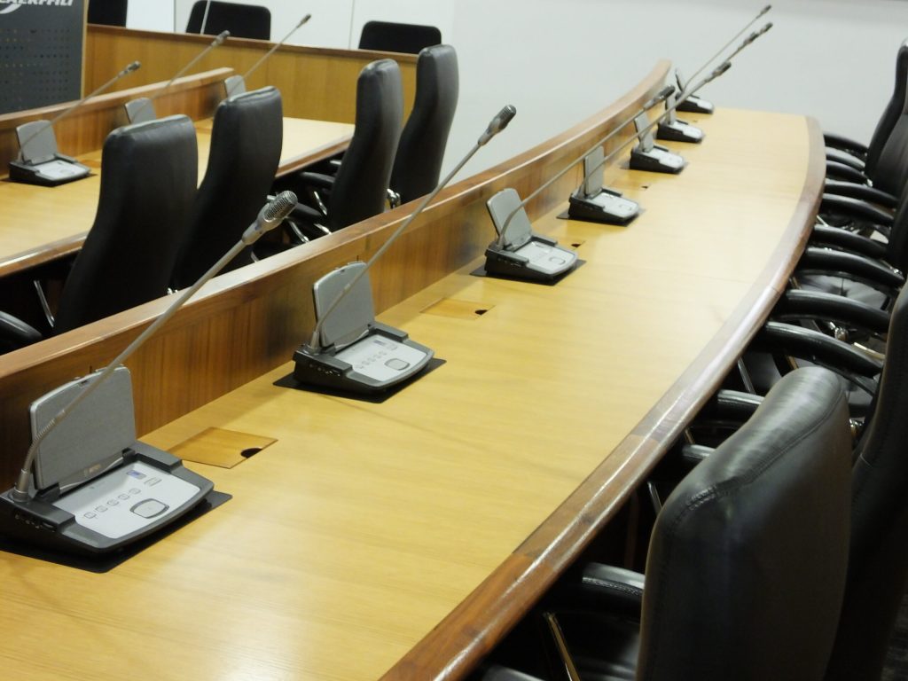 Empty conference room with microphones on tables