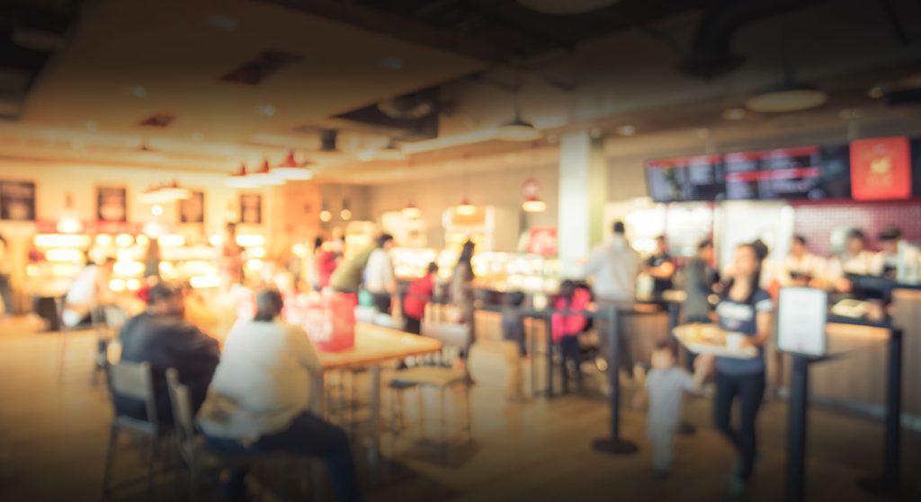 Busy restaurant featuring digital signage screens
