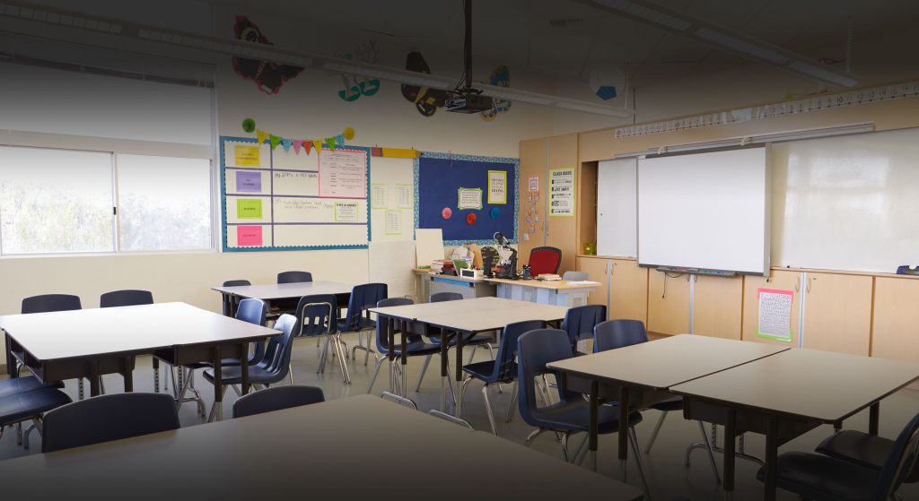 Empty school classroom with children's drawings on the wall