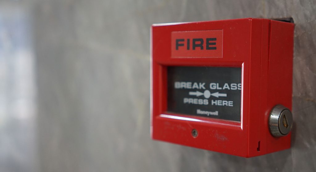 Close up of red fire alarm system mounted on a wall