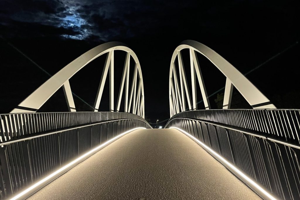 illuminated bridge walkway at night