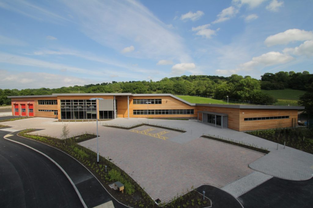 exterior image of a two storey building with car park in the foreground
