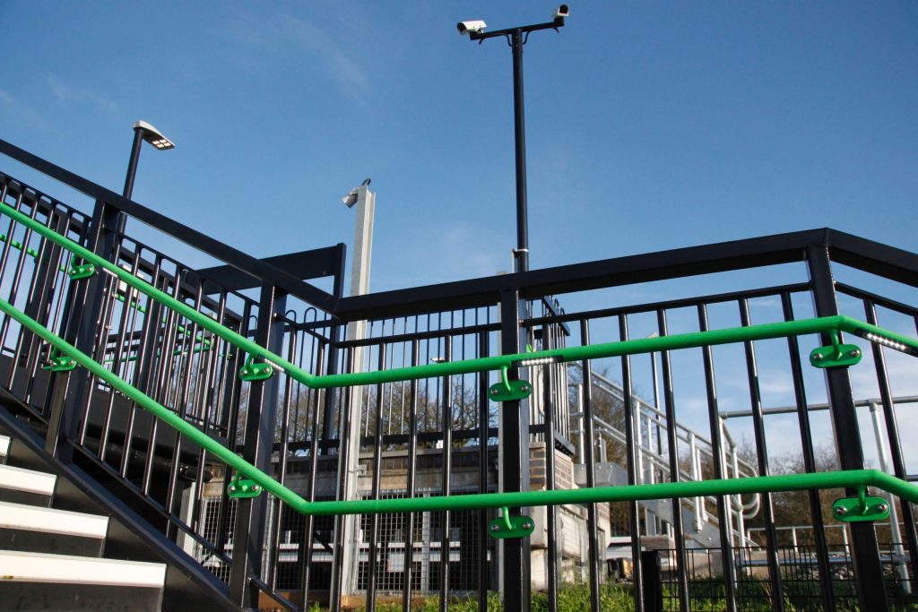 Green handrails on a bridge