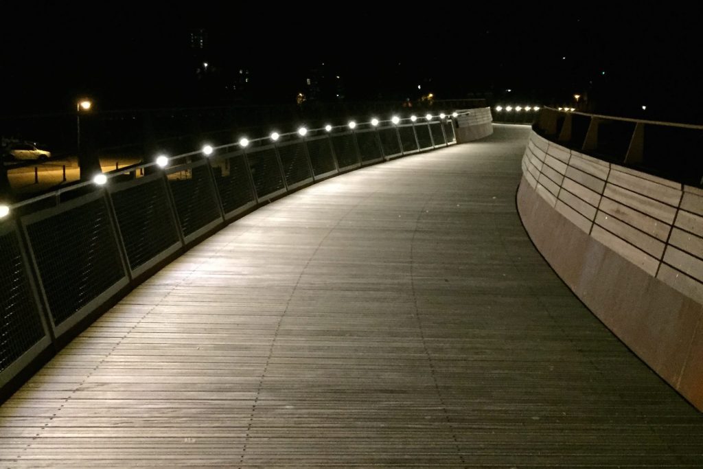 Bridge walkway illuminated at night