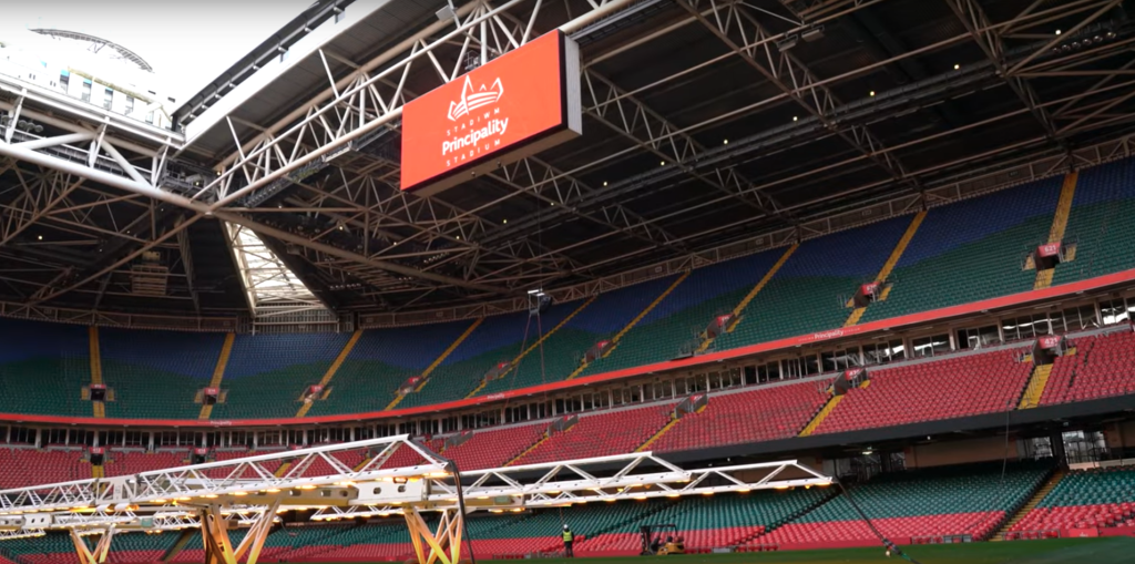 Interior of Principality Stadium looking up to a jumbotron screen with Principality Stadium branding