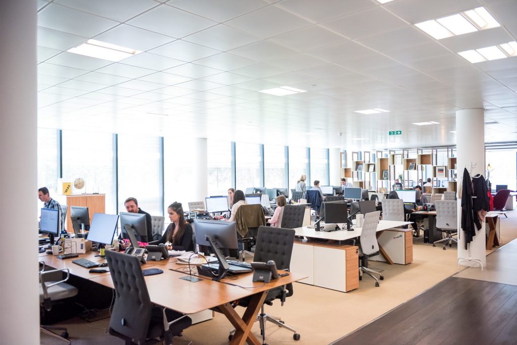 A busy open-plan office, with people working at desks