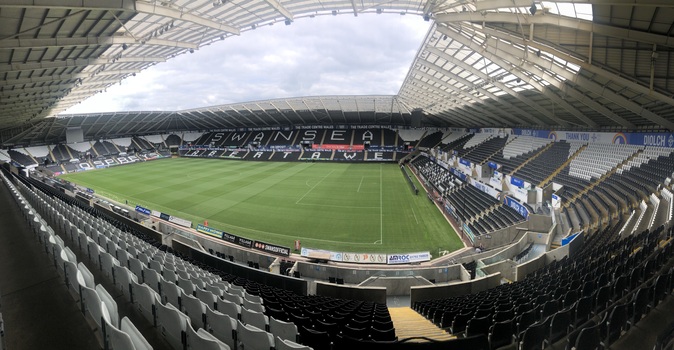 interior of a stadium taken from the corner looking onto the pitch