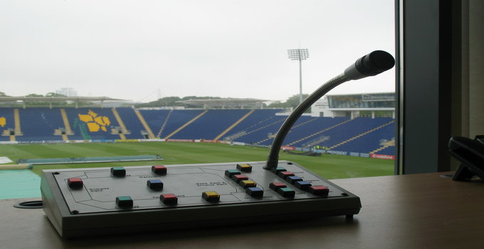 Close up of PA system with a football pitch in the background